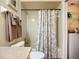 Bathroom showing a toilet, shower/tub combo with curtain, and a laundry closet with a washer and dryer at 892 Country Club Cir # 50, Venice, FL 34293