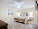 Relaxing bedroom with a queen bed, side tables, lamps, and beach themed décor at 892 Country Club Cir # 50, Venice, FL 34293