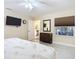 Bedroom featuring ceiling fan, TV, adjacent doors, dresser and neutral décor at 892 Country Club Cir # 50, Venice, FL 34293