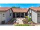 Inviting home exterior with a charming courtyard, beautiful landscaping, and walkway at 892 Country Club Cir # 50, Venice, FL 34293