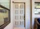 Close-up of the decorative front door and window looking into the screened front porch at 892 Country Club Cir # 50, Venice, FL 34293