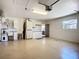 An organized two-car garage with white cabinets, a utility sink, and epoxy floors at 892 Country Club Cir # 50, Venice, FL 34293