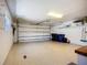 Spacious two car garage featuring a clean epoxy floor, shelving and a window at 892 Country Club Cir # 50, Venice, FL 34293