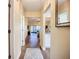 Hallway with wood flooring leading to the living room and kitchen, neutral paint at 892 Country Club Cir # 50, Venice, FL 34293