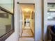 Hallway view from front door with wood floors, neutral paint, and sunlit living area at 892 Country Club Cir # 50, Venice, FL 34293