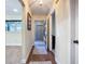 Hallway with wood flooring with two rugs, connecting rooms with neutral paint color at 892 Country Club Cir # 50, Venice, FL 34293
