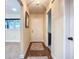 Hallway with hardwood flooring leading to living area, featuring neutral paint and carpet at 892 Country Club Cir # 50, Venice, FL 34293