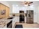 Kitchen with stainless steel appliances, granite countertops, and wood flooring at 892 Country Club Cir # 50, Venice, FL 34293