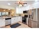 Updated kitchen with granite countertops, stainless appliances, white cabinets, and wood floors at 892 Country Club Cir # 50, Venice, FL 34293