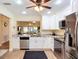 Updated kitchen featuring stainless steel appliances, white cabinets, and open layout to living room at 892 Country Club Cir # 50, Venice, FL 34293