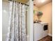 Laundry area next to a bathroom featuring a washer, dryer, shelving, and neutral paint at 892 Country Club Cir # 50, Venice, FL 34293