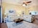 Inviting living room featuring hardwood floors and an open view to dining area, and bright light at 892 Country Club Cir # 50, Venice, FL 34293