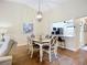 An open-concept living space includes a dining area and a breakfast bar with kitchen views at 892 Country Club Cir # 50, Venice, FL 34293
