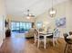 Spacious living area featuring tile floors, modern furniture, ceiling fan and access to an outdoor patio at 892 Country Club Cir # 50, Venice, FL 34293