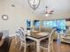 Bright living and dining area featuring wood floors, ceiling fans, and an inviting outdoor view at 892 Country Club Cir # 50, Venice, FL 34293