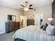 Comfortable main bedroom with carpet, and a view to the ensuite bathroom, dresser, and closet at 892 Country Club Cir # 50, Venice, FL 34293