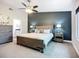 Comfortable main bedroom with carpet, and a view to the ensuite bathroom and dresser at 892 Country Club Cir # 50, Venice, FL 34293