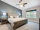 Comfortable main bedroom with a ceiling fan, carpet, and a view of the backyard from the window at 892 Country Club Cir # 50, Venice, FL 34293