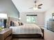 Comfortable main bedroom with a ceiling fan, carpet, and view of the yard from the window at 892 Country Club Cir # 50, Venice, FL 34293
