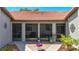 View of the screened front porch with brick flooring, neutral paint and ceiling fans at 892 Country Club Cir # 50, Venice, FL 34293