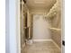 Walk-in closet with built-in shelving and racks for storing clothes and accessories at 892 Country Club Cir # 50, Venice, FL 34293