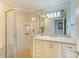 Bright bathroom featuring a glass enclosed shower and a vanity with a large mirror at 8977 Midnight Pass Rd # 519, Sarasota, FL 34242