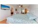 Bedroom featuring a ceiling fan, wood floors, and views of the ocean at 8977 Midnight Pass Rd # 519, Sarasota, FL 34242