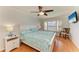 Serene bedroom featuring a waterfront view, wood floors, and modern ceiling fan at 8977 Midnight Pass Rd # 519, Sarasota, FL 34242
