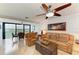 Cozy living room with leather furniture, ceiling fan, and views of the bay at 8977 Midnight Pass Rd # 519, Sarasota, FL 34242