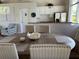 Bright dining area with wood table, upholstered chairs, and a glimpse of the kitchenette at 900 La Costa Cir # 4, Sarasota, FL 34237