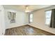 Cozy bedroom with hardwood floors, ceiling fan, and plenty of natural light from multiple windows at 1028 36Th E Ave, Ellenton, FL 34222
