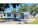 A single-story home featuring white siding, dark window trim, and a covered carport at 1028 36Th E Ave, Ellenton, FL 34222