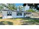 A single-story home featuring white siding, dark window trim, and a covered carport at 1028 36Th E Ave, Ellenton, FL 34222