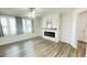 Living room area boasting modern floors, a ceiling fan, and a fireplace at 1028 36Th E Ave, Ellenton, FL 34222
