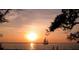 Picturesque sunset over the water with a sailboat silhouette and warm colors at 1028 36Th E Ave, Ellenton, FL 34222
