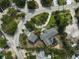 An overhead shot of a home with a pool, green lawn, complemented by mature trees in the neighborhood at 105 Island Cir, Sarasota, FL 34242