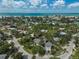 Scenic aerial view of a residential neighborhood near the ocean with vibrant greenery at 105 Island Cir, Sarasota, FL 34242