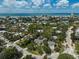 Scenic aerial view of a residential area near the beach, with lush greenery and clear blue waters at 105 Island Cir, Sarasota, FL 34242