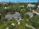 Overhead view showcases a home and its detached garage, framed by palm trees and mature landscaping at 105 Island Cir, Sarasota, FL 34242