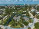 Aerial view of a property with a defined boundary, showcasing the home, landscaping, and neighborhood at 105 Island Cir, Sarasota, FL 34242