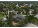 Stunning aerial view of a home featuring a screened-in pool, set amidst lush greenery at 105 Island Cir, Sarasota, FL 34242