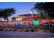 Festive outdoor dining area with colorful lights and lively atmosphere, perfect for enjoying a meal and drinks at 105 Island Cir, Sarasota, FL 34242