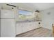 A well-lit kitchen with white appliances and plenty of counter space that create a clean and functional space at 105 Island Cir, Sarasota, FL 34242