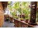 Cozy outdoor patio with wooden deck, lush greenery, potted plants, and a rustic 'Patio' sign for a relaxed atmosphere at 105 Island Cir, Sarasota, FL 34242