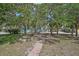 Community park featuring a bench, walkway, landscaping and mature trees at 105 Island Cir, Sarasota, FL 34242