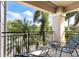 Outdoor balcony with seating and serene views of lush greenery and a golf course at 1064 N Tamiami Trl # 1133, Sarasota, FL 34236