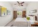 Bright bedroom featuring neutral decor, ceiling fan, and bookshelves at 1064 N Tamiami Trl # 1133, Sarasota, FL 34236