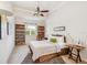 Comfortable bedroom with natural light, ceiling fan, and built-in bookshelves at 1064 N Tamiami Trl # 1133, Sarasota, FL 34236