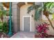 Private condo entrance surrounded by lush tropical plants and elegant landscaping at 1064 N Tamiami Trl # 1133, Sarasota, FL 34236