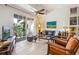 Living room featuring tile flooring, an outside balcony, and comfortable seating at 1064 N Tamiami Trl # 1133, Sarasota, FL 34236